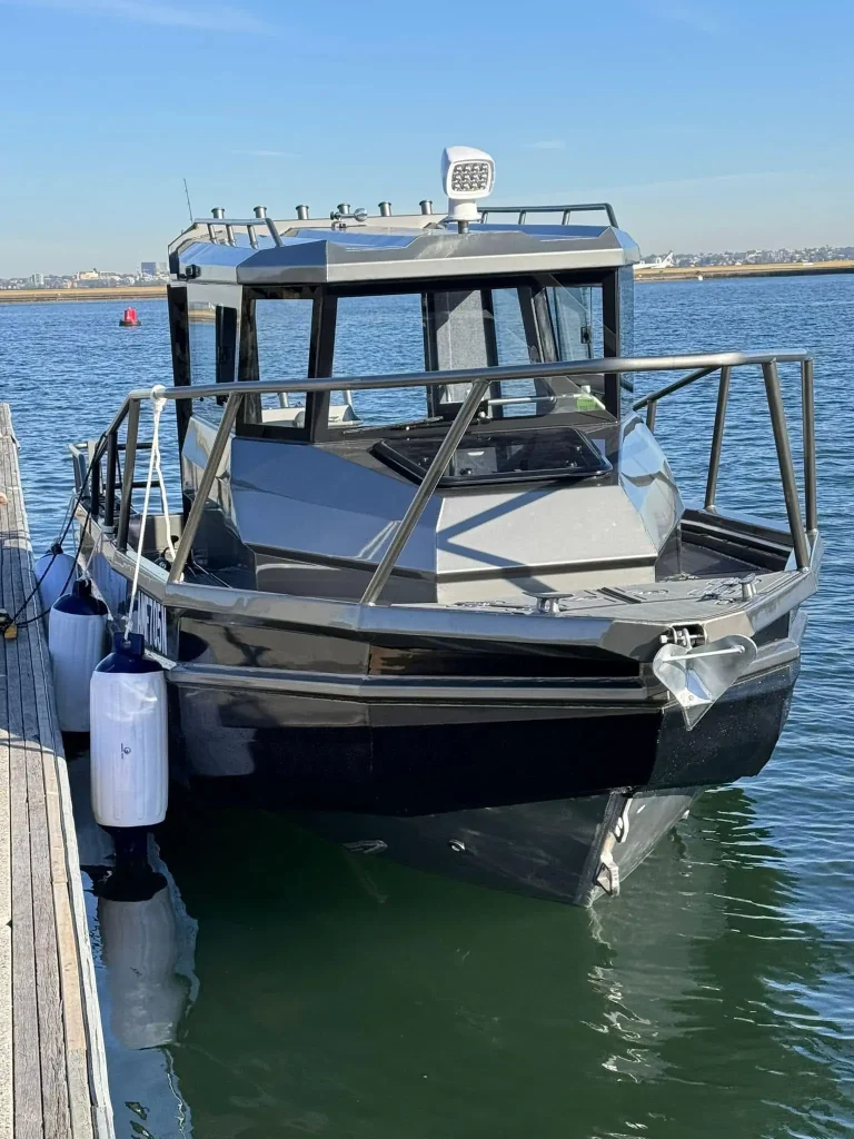 Plate aluminium hardtop boat moored on calm water