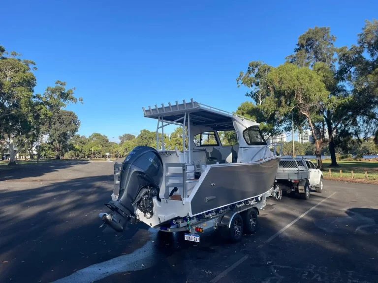 Plate aluminium hardtop boat on a trailer at the ramp