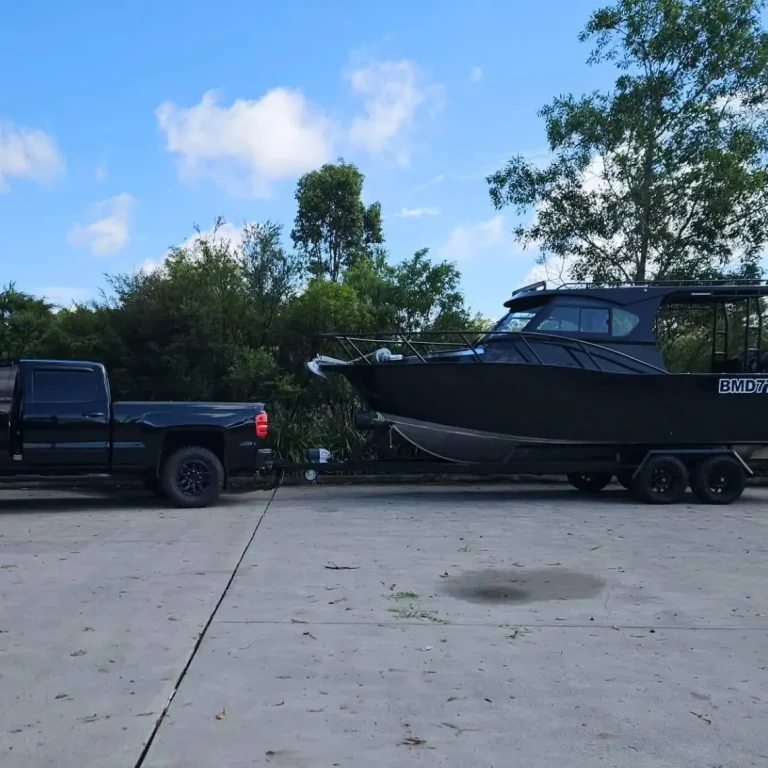 Plate aluminium hardtop boat on a trailer behind a ute