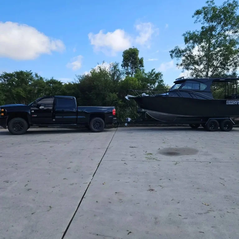 Plate aluminium hardtop boat on a trailer behind a ute