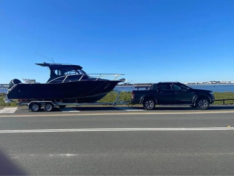 Plate aluminium hardtop boat on a trailer behind a ute