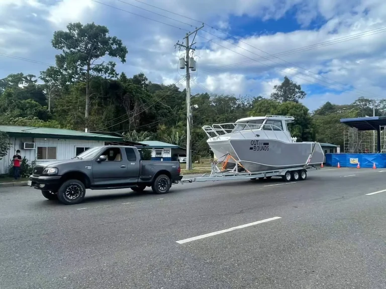 Plate aluminium hardtop boat towed behind a ute