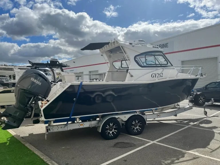 Plate aluminium hardtop boat with outboard on a trailer
