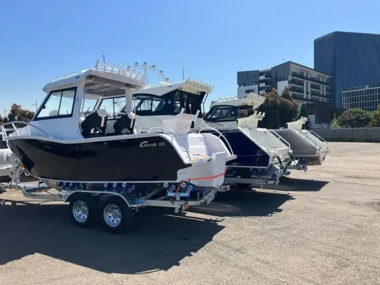 Plate aluminium hardtop boats on trailers at a city marina