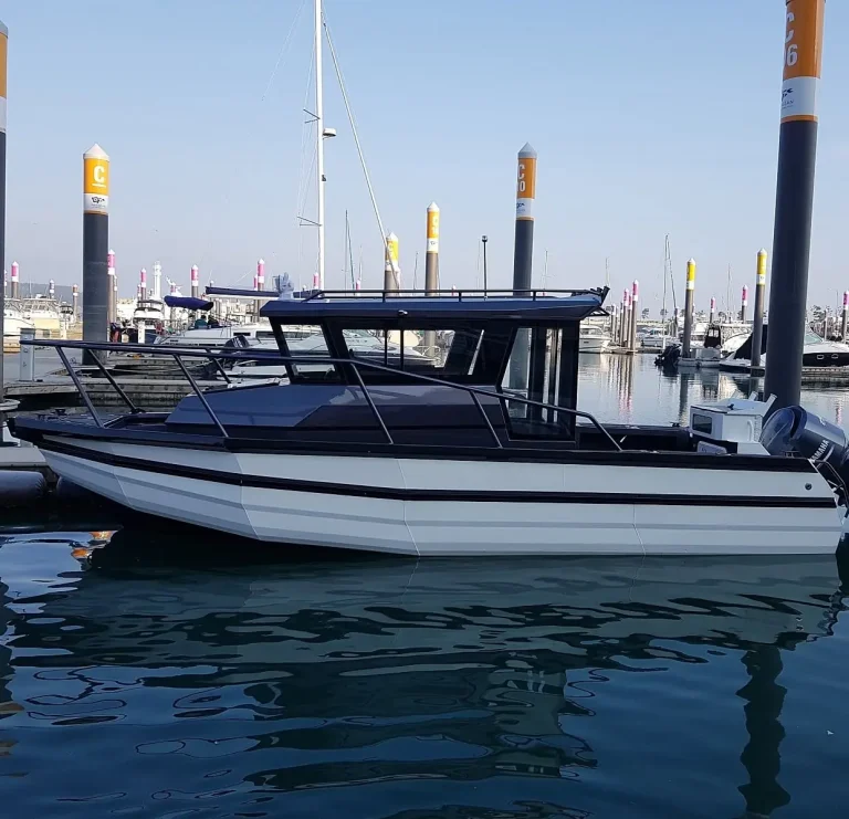 Plate aluminium hardtop cabin boat berthed in a marina