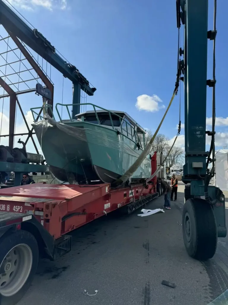 Plate aluminium hull craned onto a truck