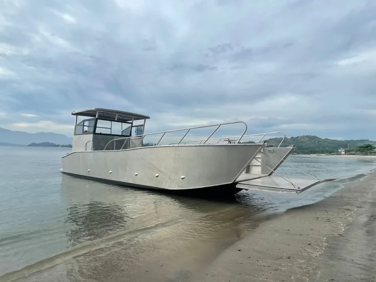 Plate aluminium landing craft beached on the sand