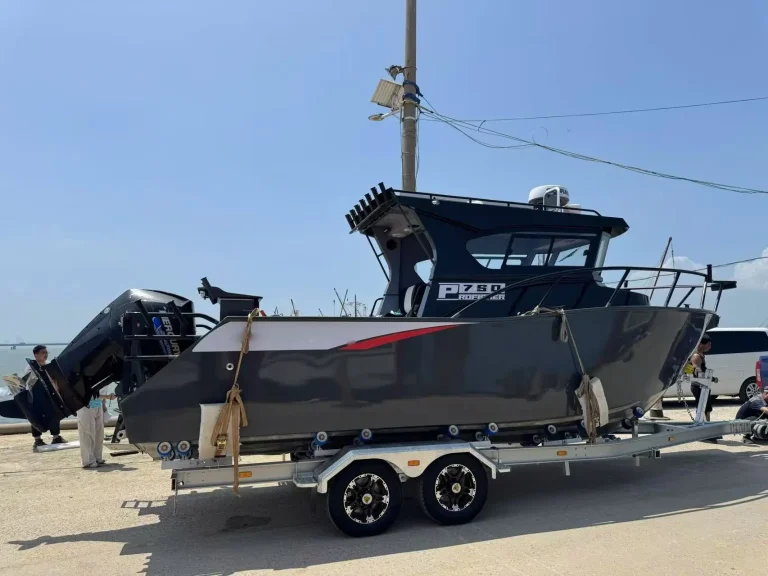 Plate aluminium patrol boat on a tandem trailer