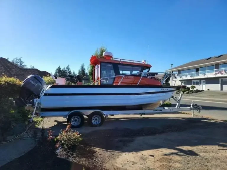 Plate aluminium work boat on a trailer at the ramp