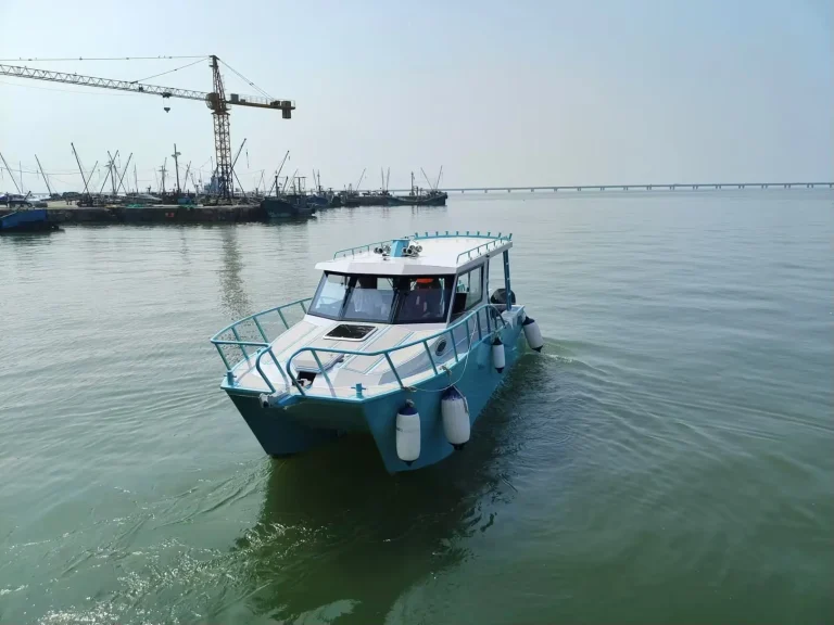 Plate aluminium work boat under way in a harbour