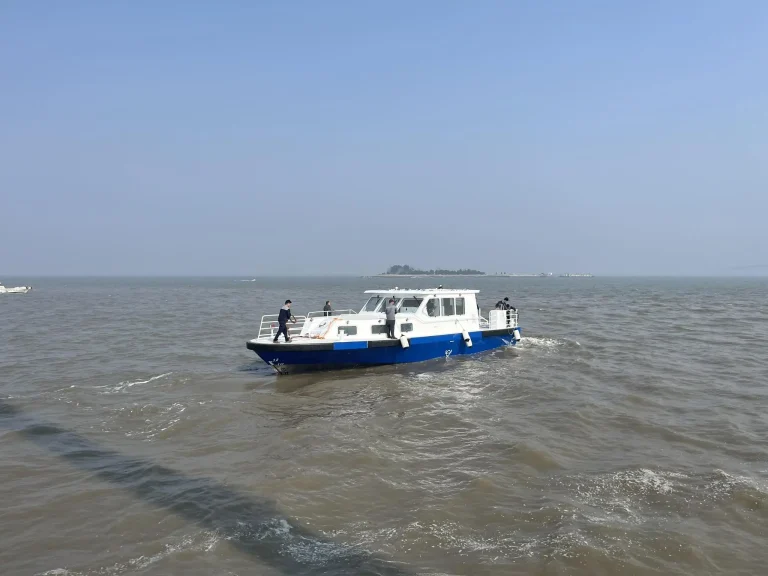 Plate aluminium work boat under way on open water
