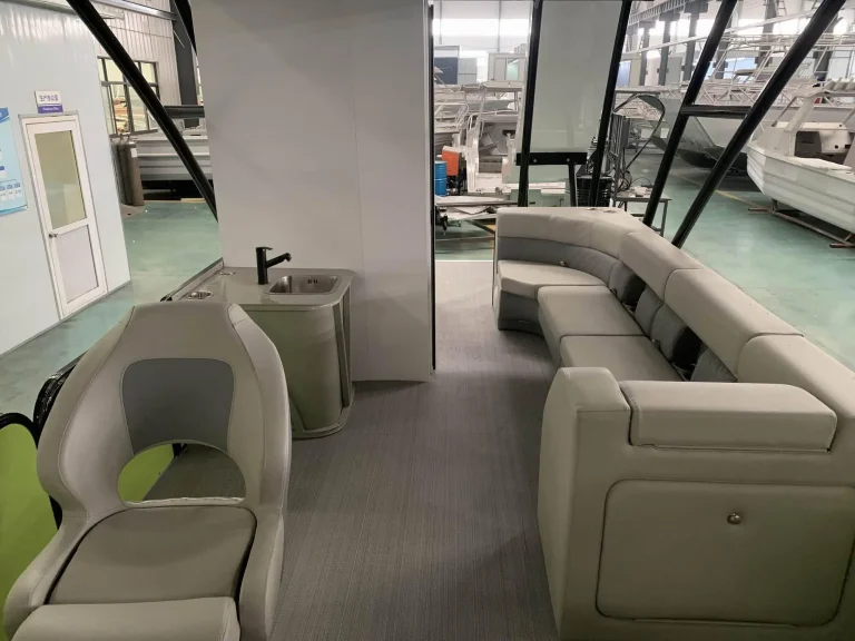 Pontoon boat interior with lounge seats and galley