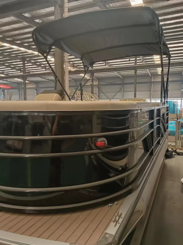 Pontoon boat with bimini top under cover