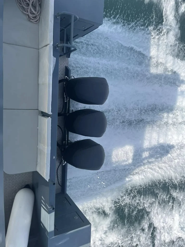 Quad outboards running behind a plate aluminium boat