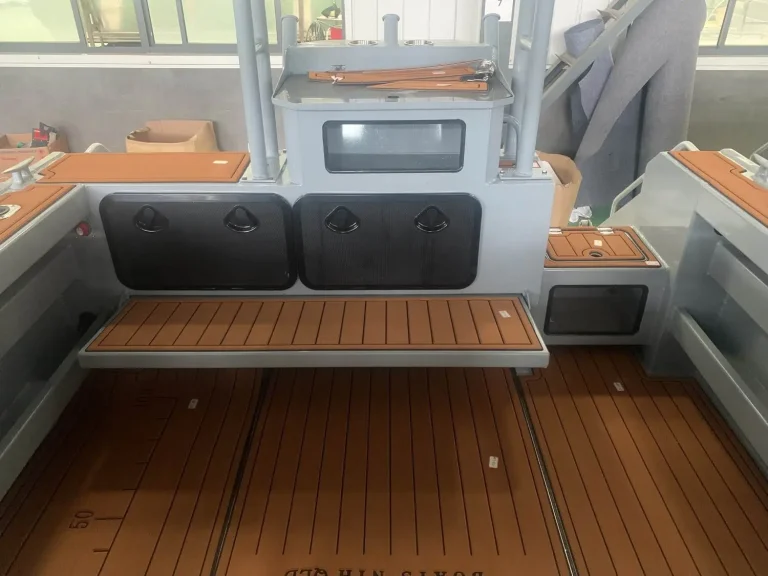 Rear lounge and teak look deck inside a cabin boat
