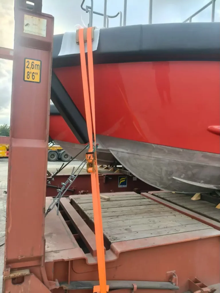 Red hull strapped for transport