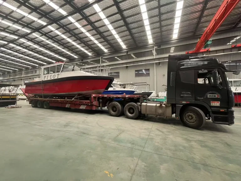 Red pilot boat loaded on a truck for delivery