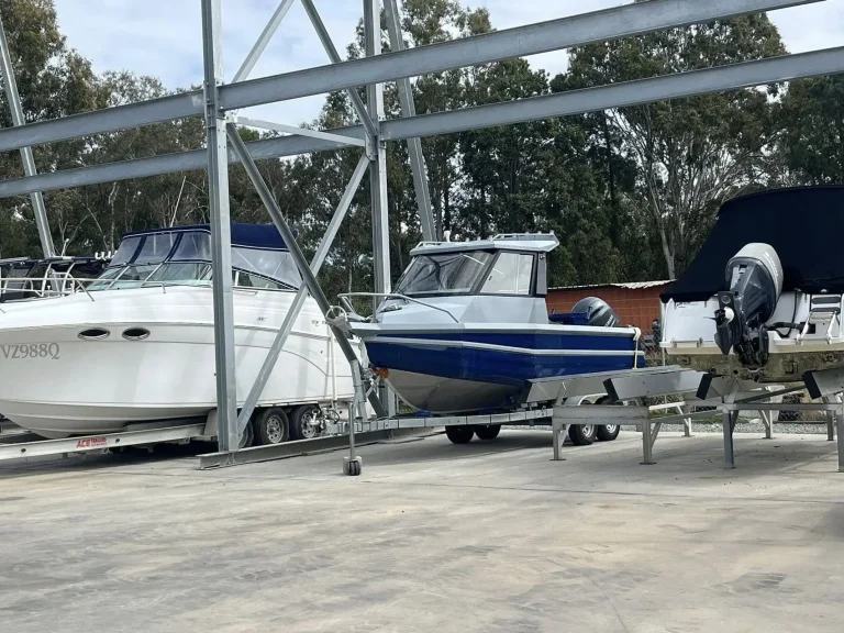 Row of plate aluminium boats on trailers at the dealership