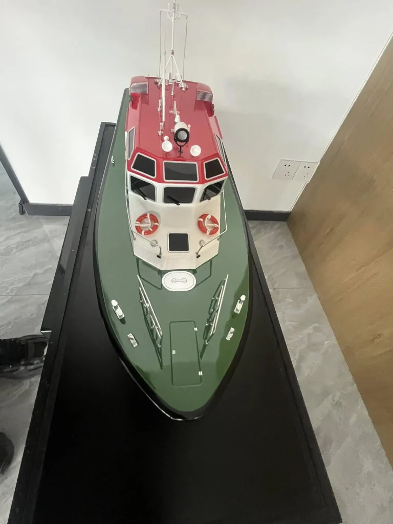 Scale model of a green hulled work boat