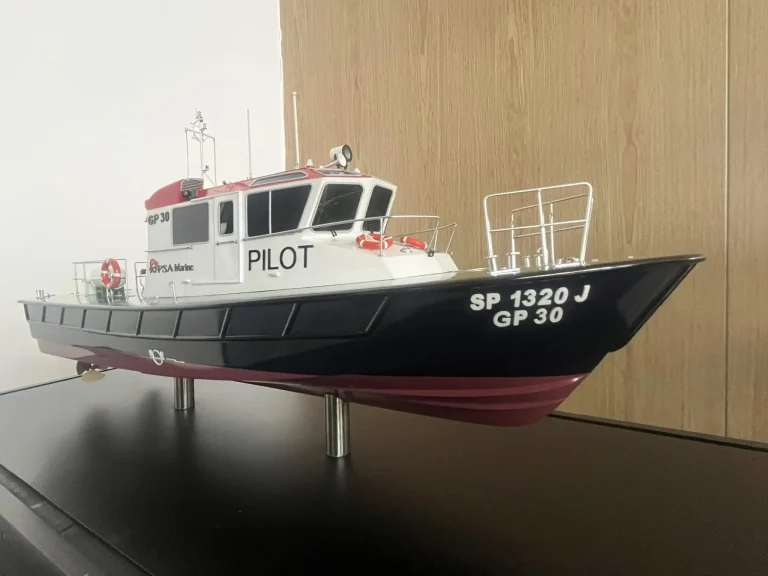 Scale model of a red and white pilot boat