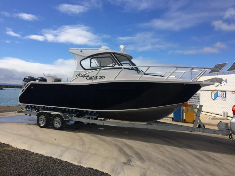 Side view of a black hardtop plate aluminium fishing boat