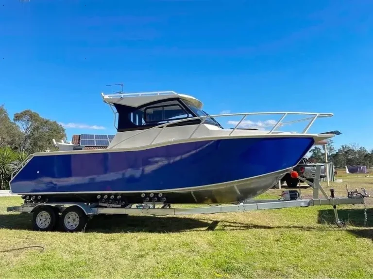 Side view of a blue plate aluminium hardtop boat