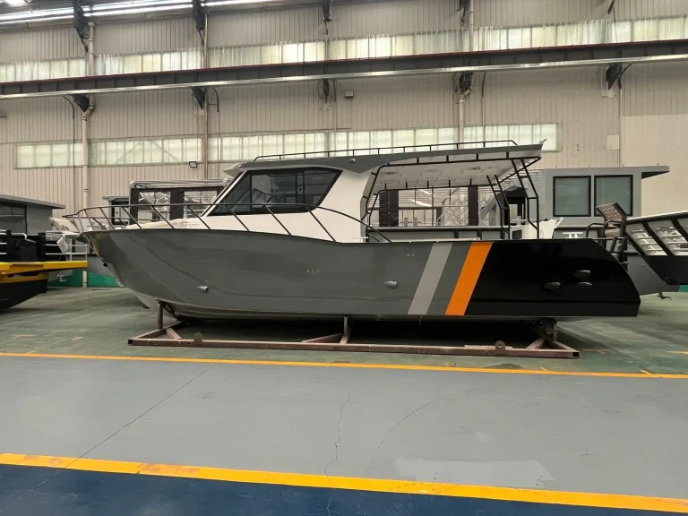 Side view of a work boat with orange stripe