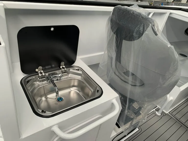 Stainless galley sink and tap inside a cabin boat