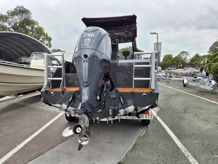 Stern and outboard of a hardtop boat on a trailer