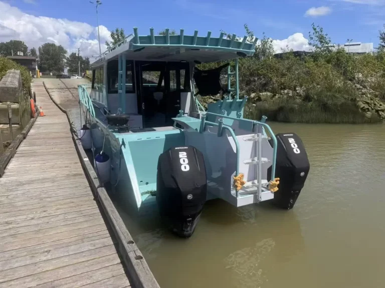 Teal plate aluminium boat moored at a river jetty