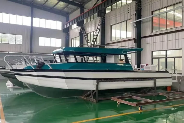 Teal roofed plate aluminium cabin boat on the factory floor