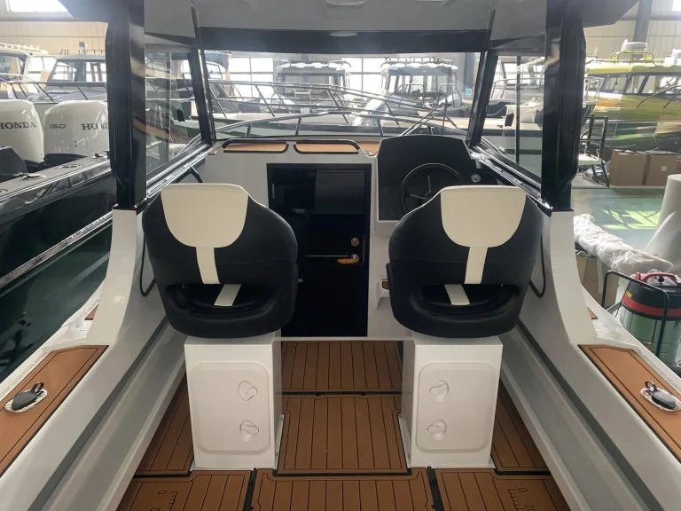 Twin bucket seats over teak look cockpit flooring