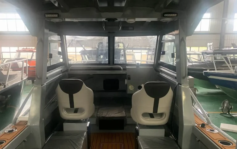 Twin cream helm seats inside a hardtop cabin