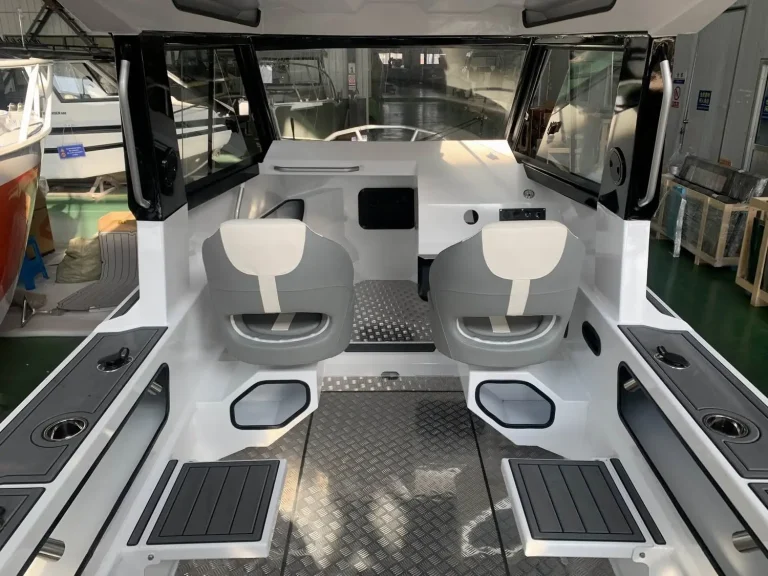 Twin helm seats and console with teak look flooring