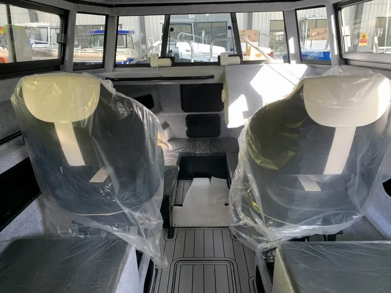 Twin helm seats in wrap inside a plate aluminium wheelhouse
