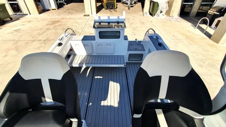 Twin helm seats over a teak look cockpit floor