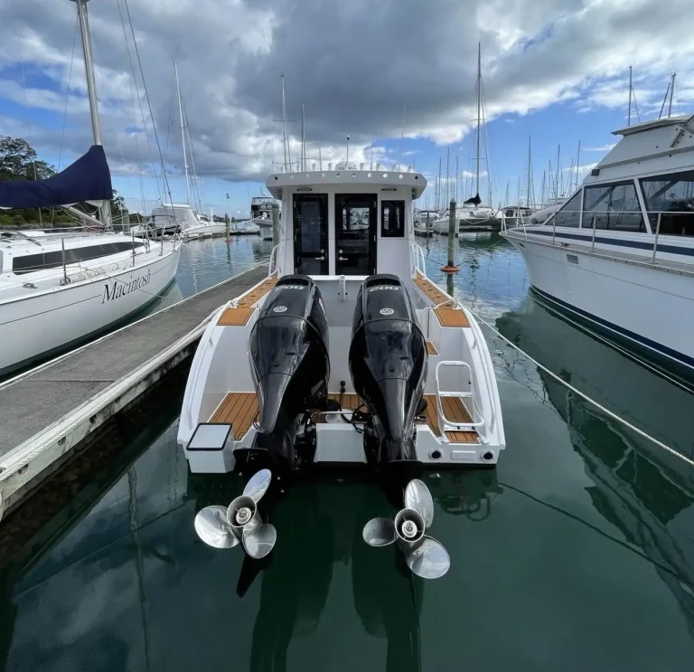 Twin outboards on the transom of a boat berthed in a marina
