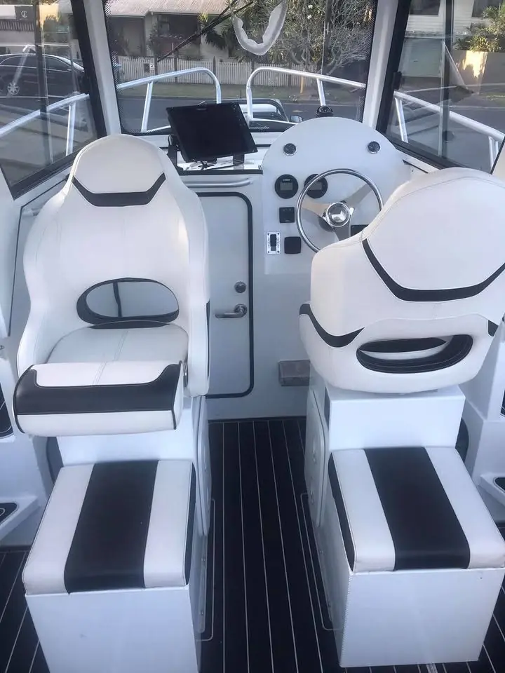 Twin white helm seats and dash on a centre console