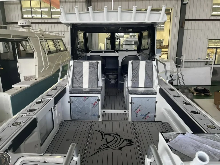 Twin wrapped helm seats over a teak look cockpit floor