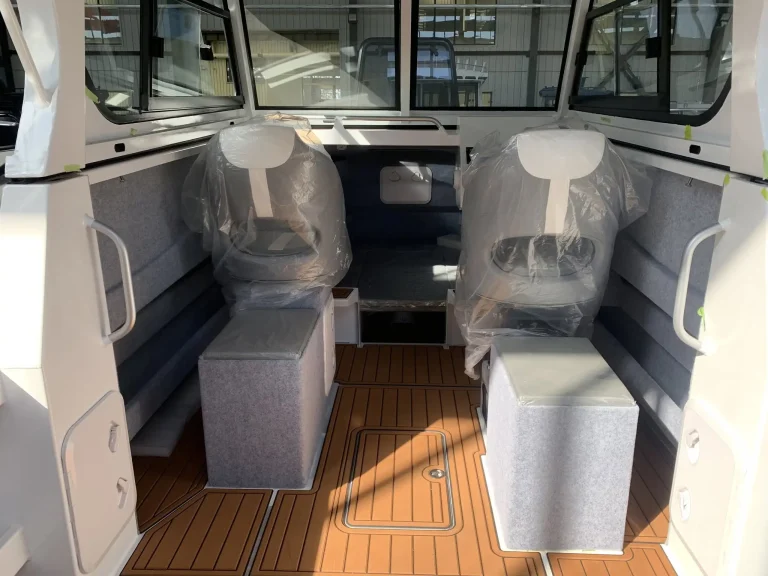 Twin wrapped helm seats over a teak look cockpit floor