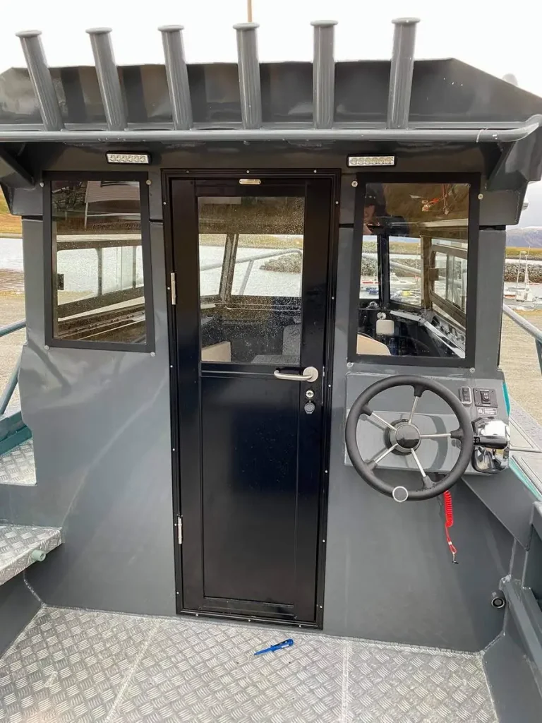 Wheelhouse door and helm on a plate aluminium work boat