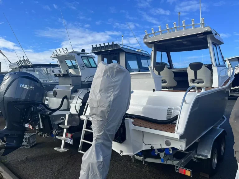 White centre console with wrapped seats on a trailer