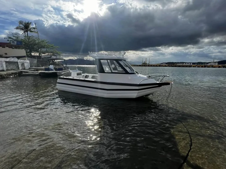 White hardtop plate aluminium boat on calm water at dusk