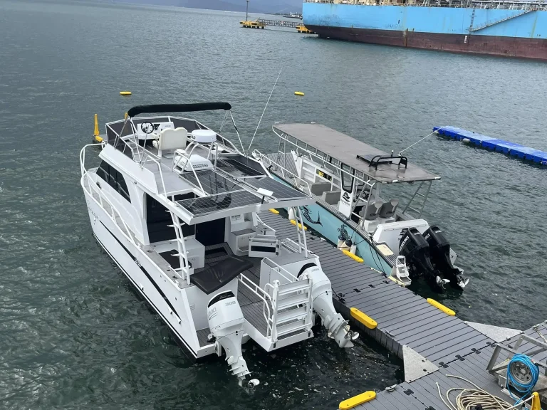 White plate aluminium charter boat at a pontoon