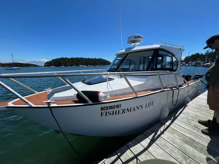 White plate aluminium charter boat berthed in a bay