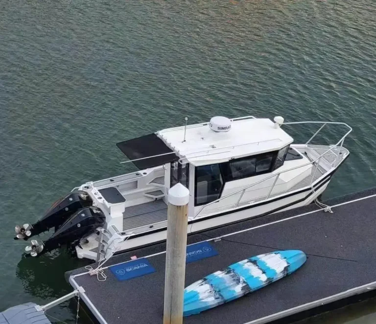 White plate aluminium cruiser berthed at a private jetty