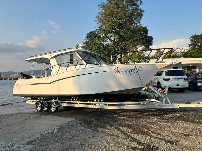 White plate aluminium hardtop boat on a trailer