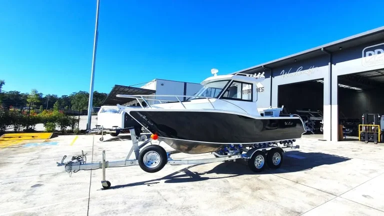 White plate aluminium hardtop boat on a trailer in the sun