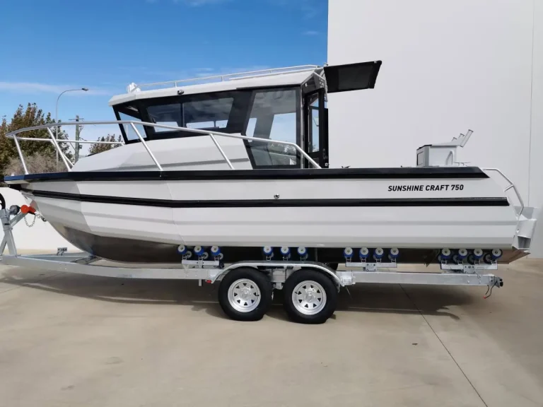 White plate aluminium hardtop boat with hydraulic top on a trailer