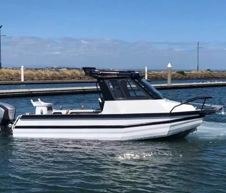 White plate aluminium hardtop cabin boat with black roof at the marina
